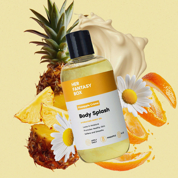Her Fantasy Box Pineapple Crème Body Splash hydrating body oil bottle surrounded by pineapple, citrus, and daisy blooms on yellow background