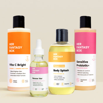 Her Fantasy Box Vita C Bright body wash, Renew Her oil, Pineapple Crème Body Splash, and Sensitive Probiotic+ wash product lineup on neutral background