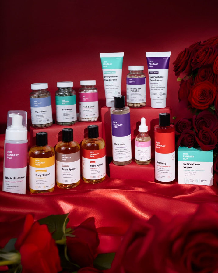 Her Fantasy Box product collection — Boric Balance, Body Splashes, supplements, Refresh, Yummy, Everywhere Wipes and Deodorant on red satin with roses