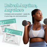 Lifestyle image of woman lifting weights beside Her Fantasy Box Everywhere Wipes packets for compact on-the-go freshness