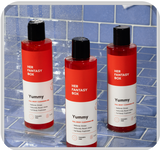 Her Fantasy Box Yummy full body cleansing gel 3-pack displayed on a blue tile shower shelf
