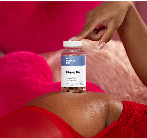 Person holding a bottle labeled 'Slippery Box' against a pink background