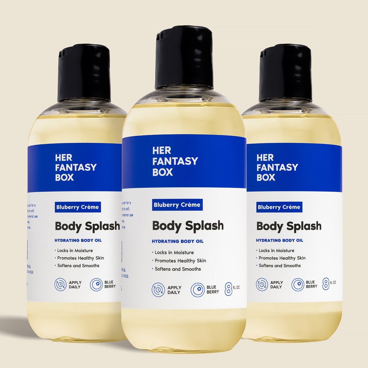 Three bottles of Her Fantasy Box Blueberry Crème Body Splash hydrating body oil displayed together on neutral background
