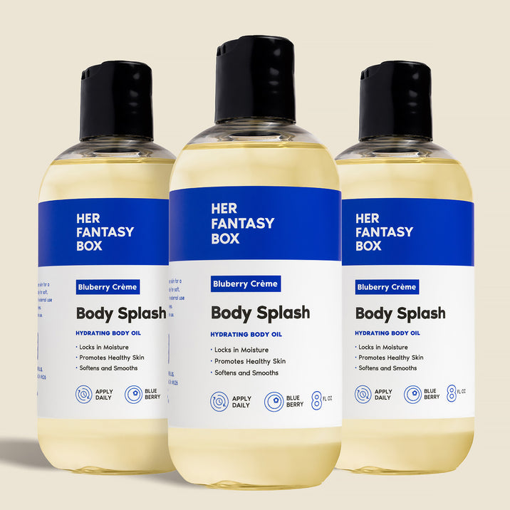Three bottles of Her Fantasy Box Blueberry Crème Body Splash hydrating body oil displayed together on neutral background