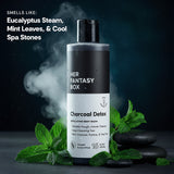 Smells Like: Eucalyptus Steam, Mint Leaves, & Cool Spa Stones. Her Fantasy Box Charcoal Detox Exfoliating Body Wash – Smooths Rough, Uneven Texture, Deep-Cleansing Feel, With Charcoal, Pumice, & Tea Tree. Steamy Eucalyptus, 16 fl oz / 473 mL. Bottle surrounded by mint leaves and black spa stones with steam rising.