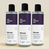 Three bottles of 'HER FANTASY BOX Refresh' feminine cleansing gel on a beige background