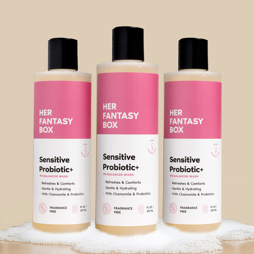 Three bottles of 'Her Fantasy Box' sensitive probiotic products on a beige background