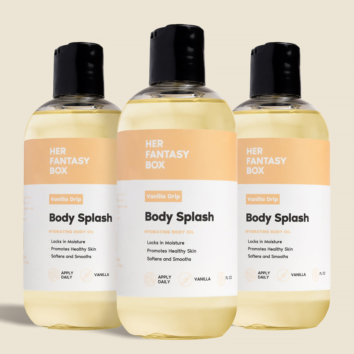 Three bottles of Her Fantasy Box Vanilla Drip Body Splash hydrating body oil displayed together on neutral background